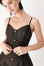 Dark patterned midi dress bodice with spaghetti straps and gold buttons detail