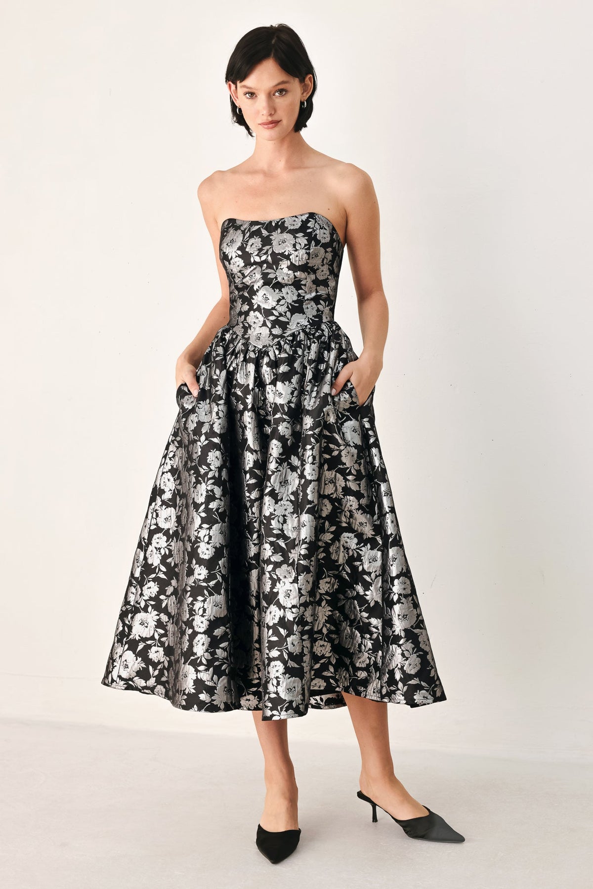 Black strapless sweetheart midi dress with white floral print and gathered skirt