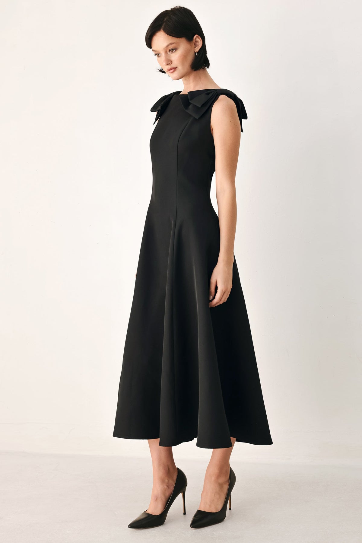 Black bow-shoulder midi dress, full skirt flare and high neckline