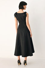 Black bow-shoulder midi dress from back, sleeveless cut and flared hem