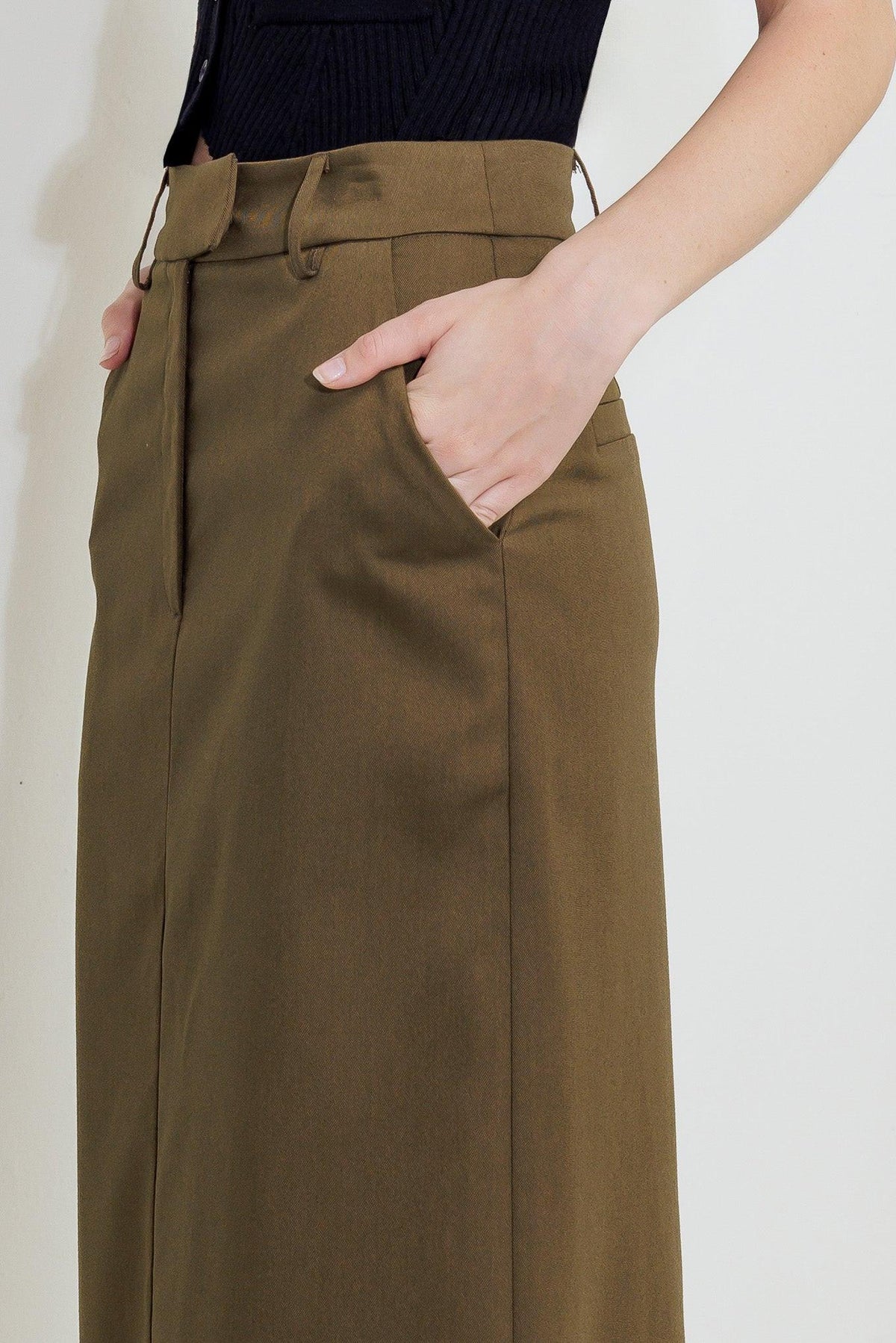 Woven skirt in olive brown with belt loops, front pockets, and buttoned waistband