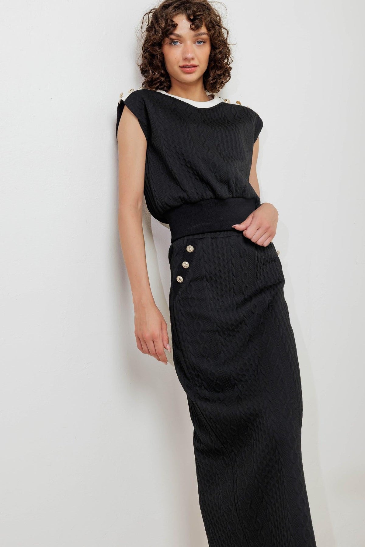 Black knit midi skirt with front button accents and front slit