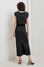 Black knit midi skirt with front slit and textured fabric; back view