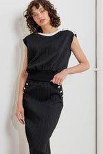 Black knit midi skirt with button accents at the front waist and side slit