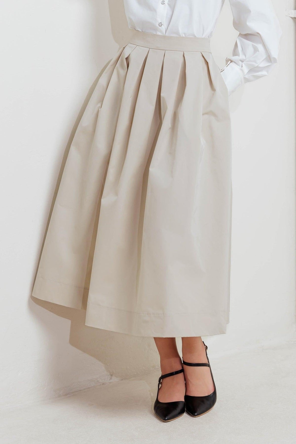 Cream woven full midi skirt with pleated panels and waistband at the waist