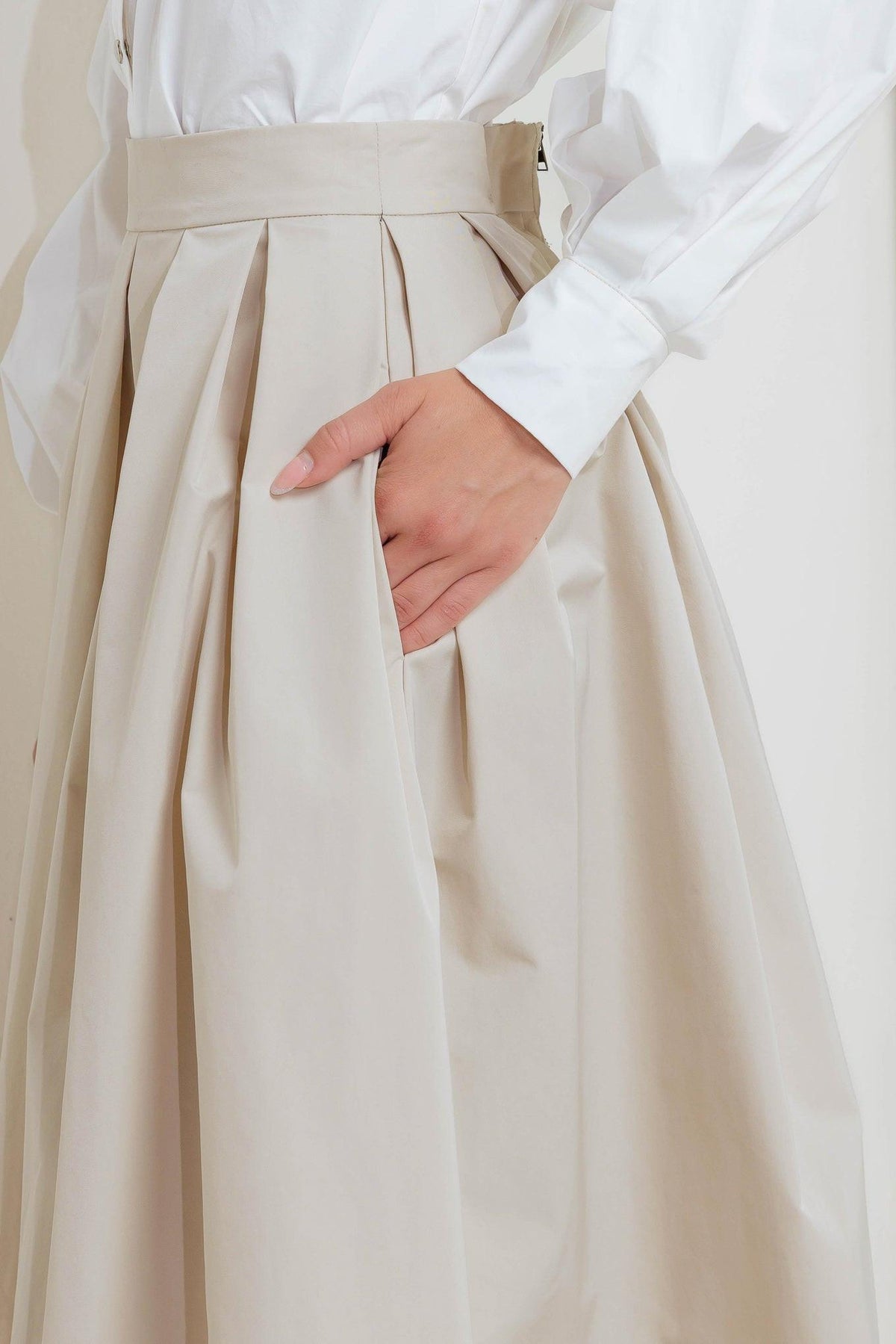 Cream woven midi skirt with vertical pleats and buttoned waistband seam