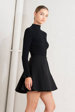 Black high-waist mini skirt with knife pleats and flared hem, angled view