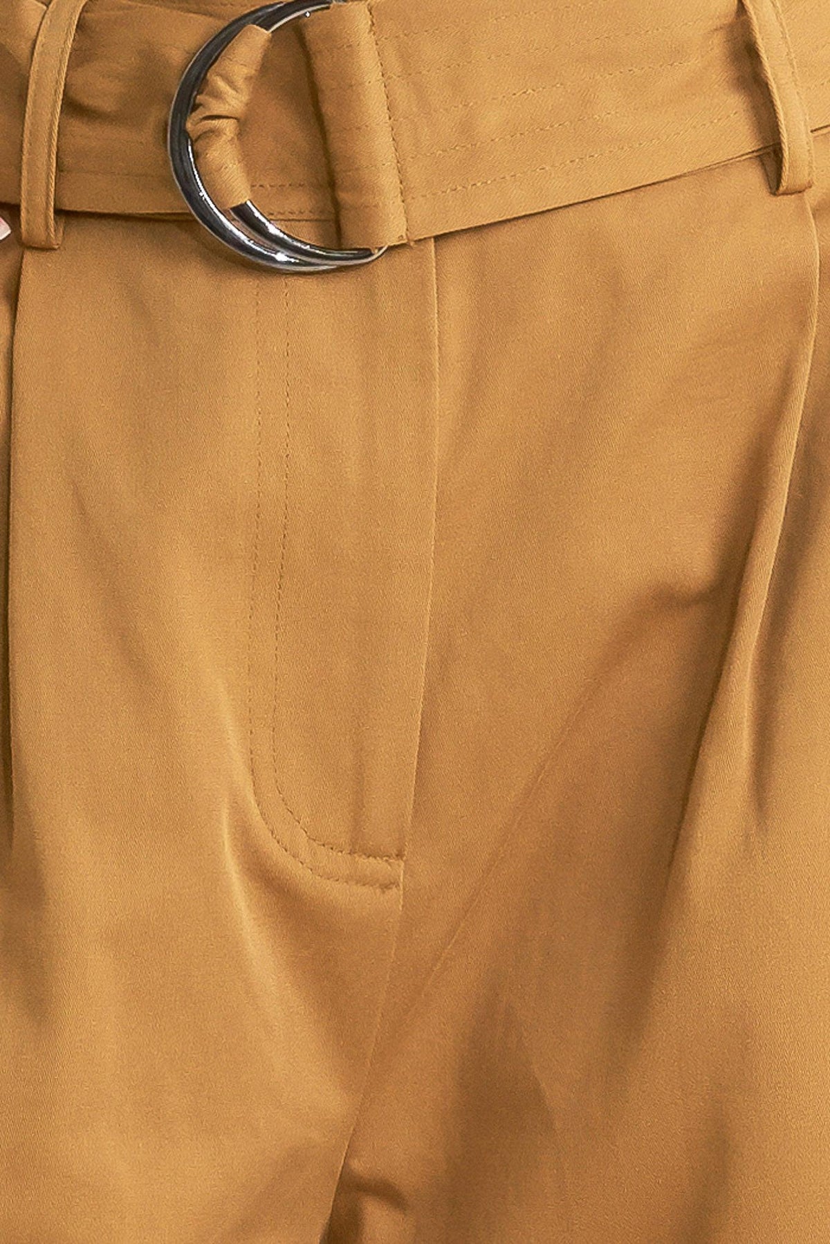 Camel woven pants close-up of front seam, side pocket, and button fly detail