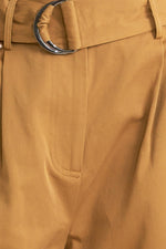 Camel woven pants close-up of front seam, side pocket, and button fly detail