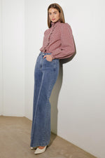 Medium wash stretch denim flared jeans with front pockets and belt loops
