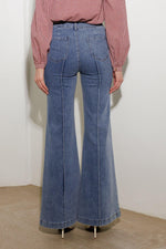 Medium wash stretch denim wide-leg pants with back pockets and belt loops