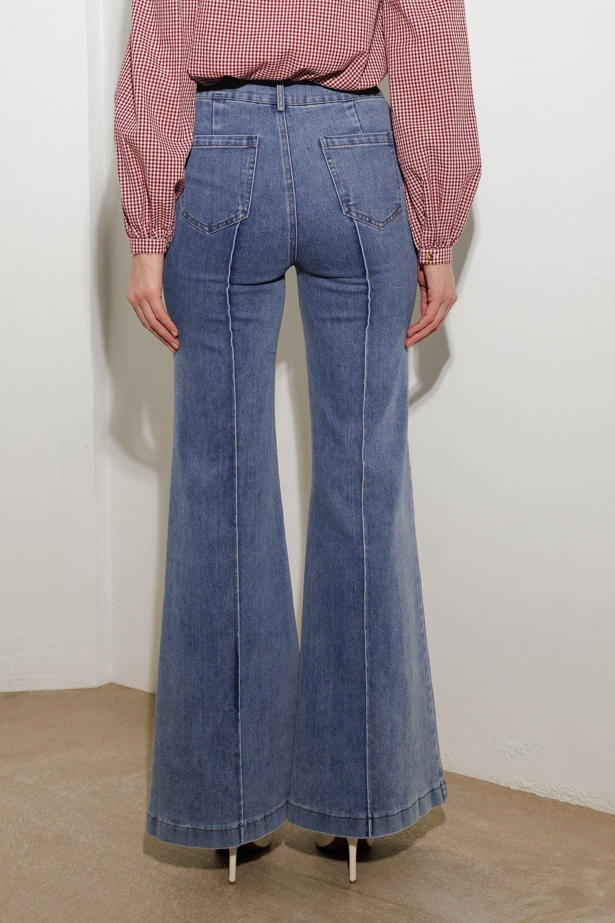 Medium wash stretch denim wide-leg pants with back pockets and belt loops