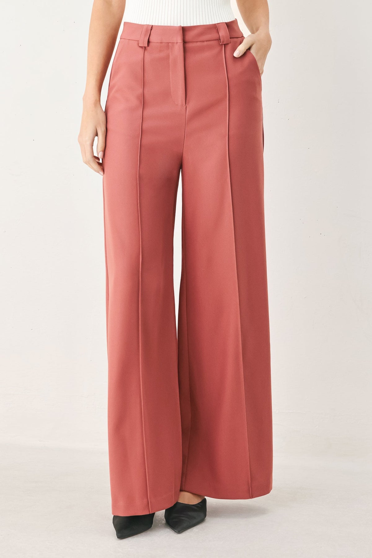Dried rose woven wide-leg pants with high waist, center crease, belt loops, pockets.