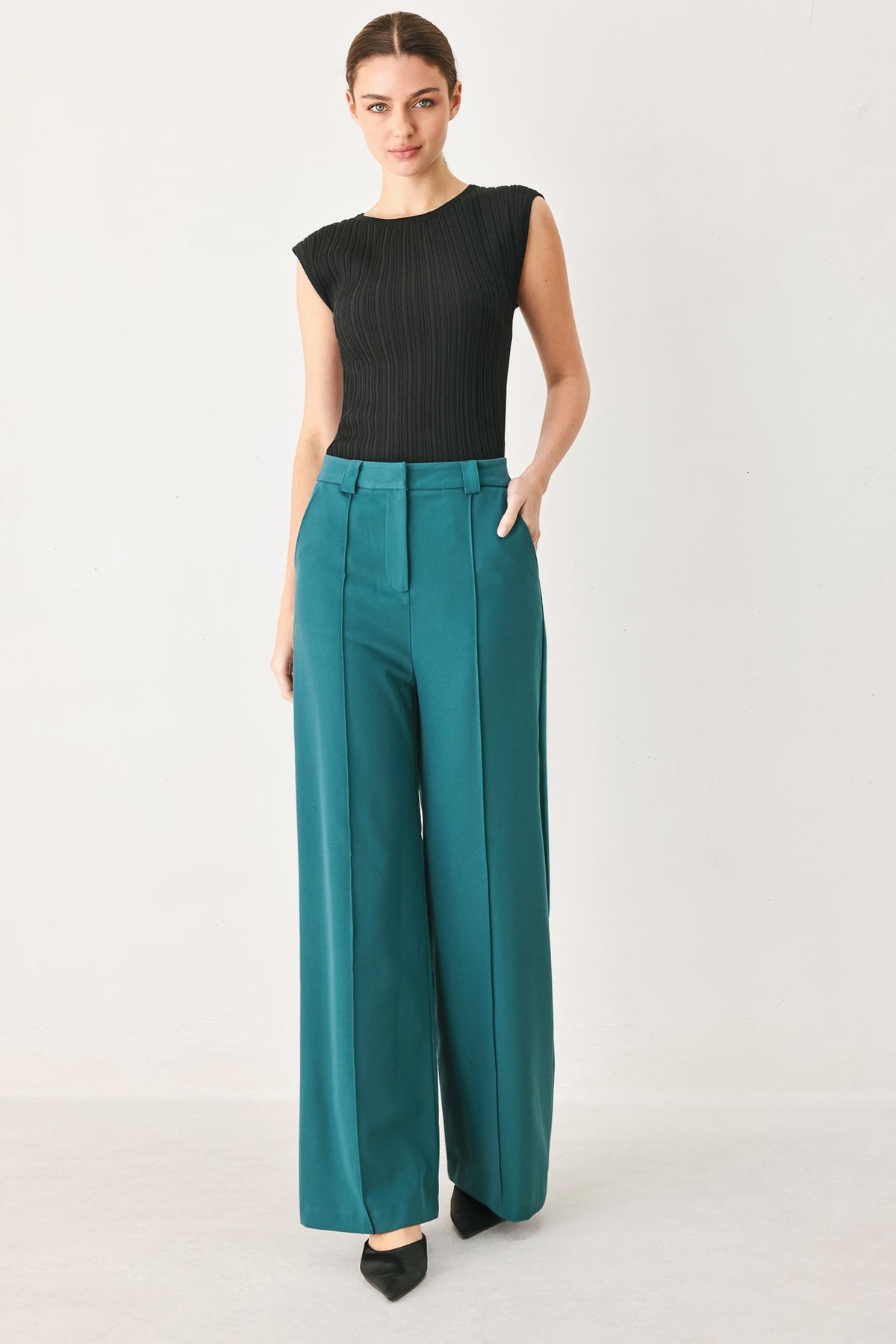 Teal woven high-waist wide-leg trousers with front pleats, belt loops, side pockets.