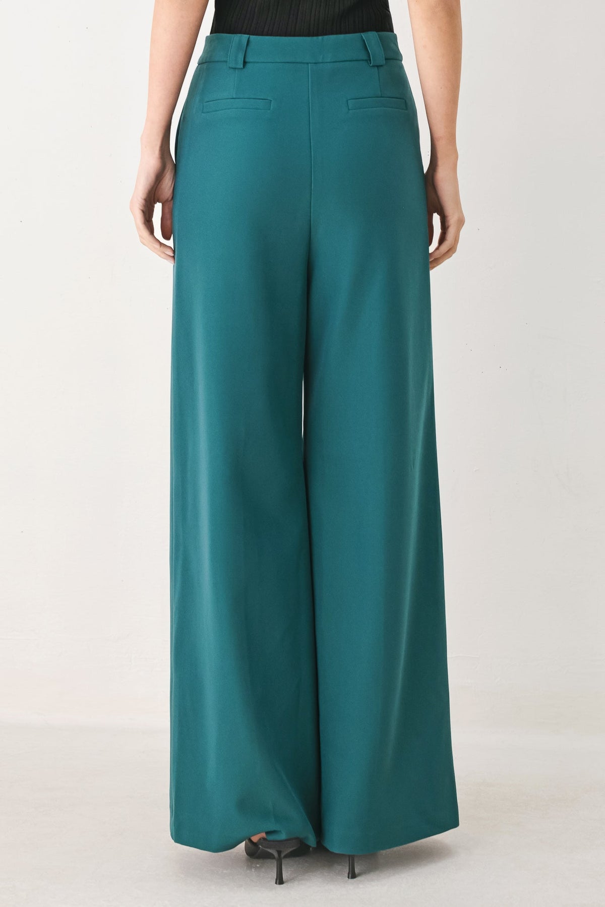 Teal woven wide-leg pants with high waist and belt loops, straight draped legs.