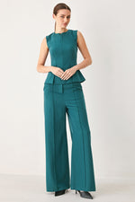 Teal woven wide-leg pants with high-rise waist, stitched seams, belt loops, side pockets.
