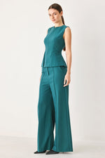 Teal wide-leg woven pants with high waist, front crease, belt loops, side pockets.