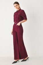 Women’s burgundy high-rise wide-leg twill pants with button front and front seaming.