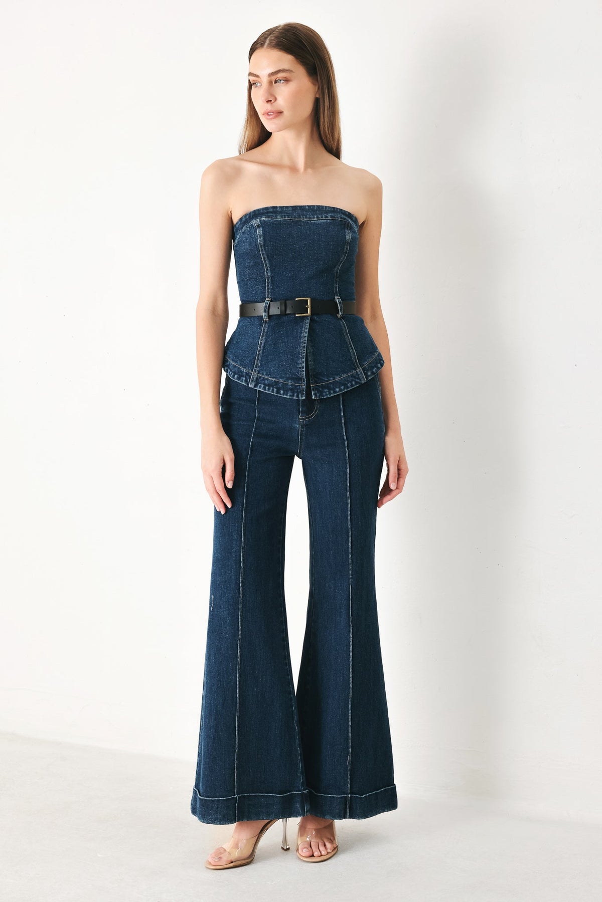 Indigo denim flare pants with high waist, belt loops, and wide flared hems