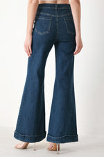 Indigo denim flare pants front view with stitched pockets and wide bell legs