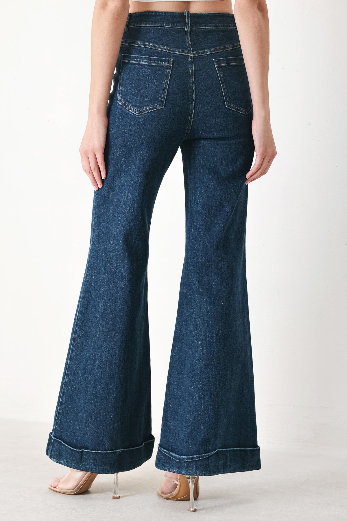 Indigo denim flare pants front view with stitched pockets and wide bell legs