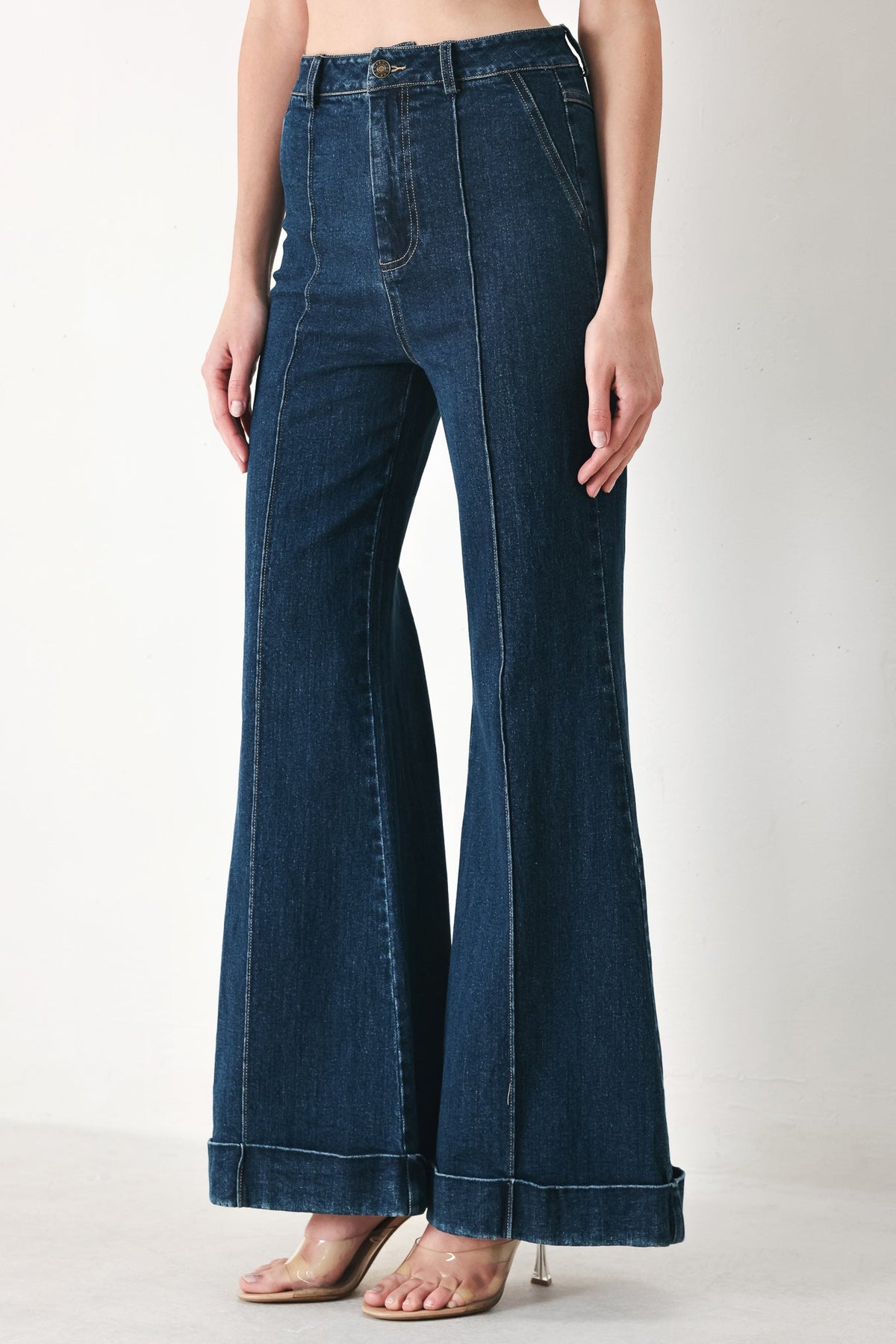 Indigo denim flare pants with wide bell legs and front seam detailing