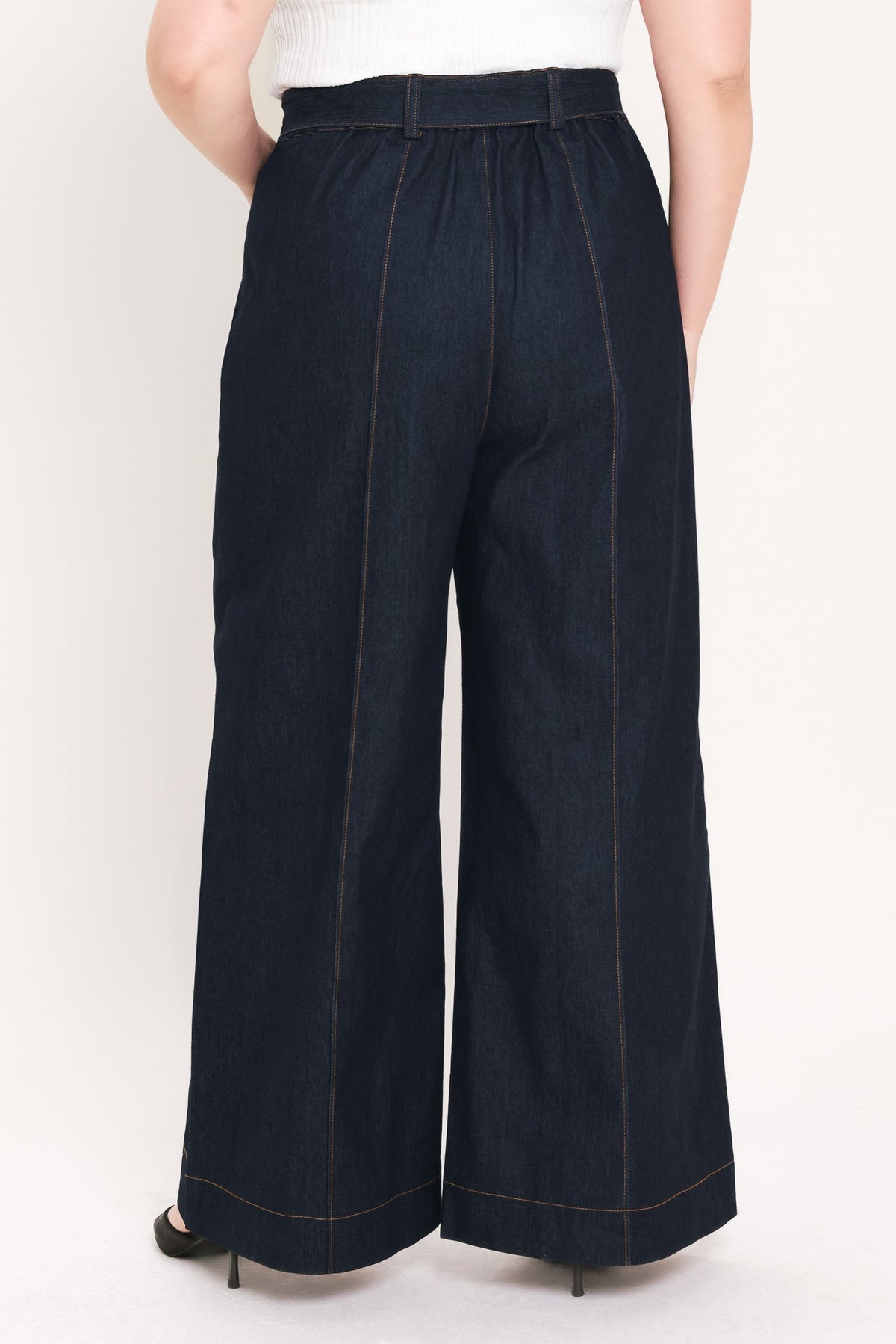 Dark denim wide-leg jeans with structured high waist, belt loops, and contrast vertical seams