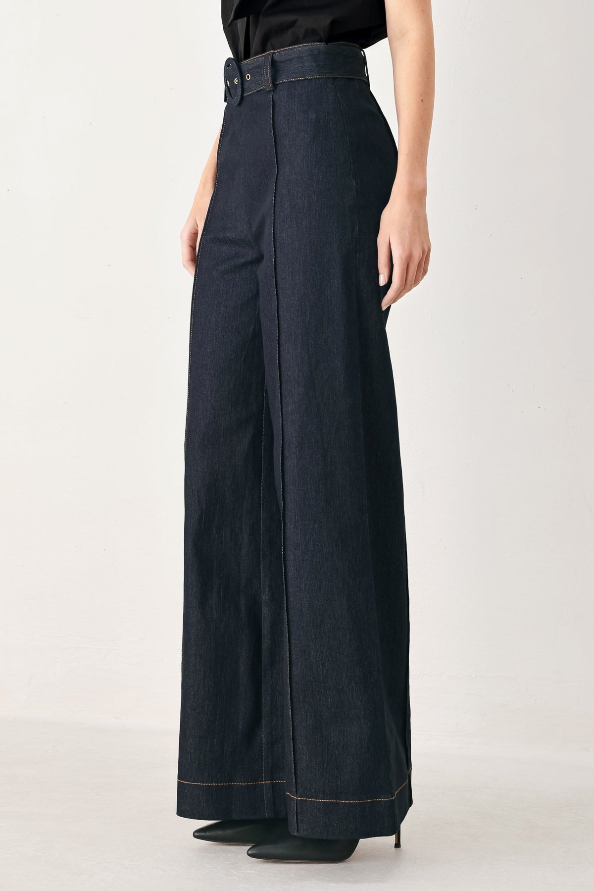 Dark denim wide-leg pants with back yoke, center seam, and contrast hem stitching