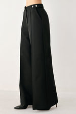 Black high-waisted wide-leg palazzo pants with structured drape and belt loops