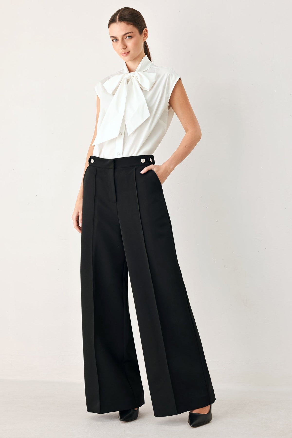 Black high-waisted wide-leg palazzo pants with button-tab waistband and belt loops