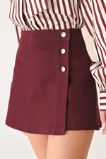 Burgundy woven skort with side-button closure and A-line skirt overlay