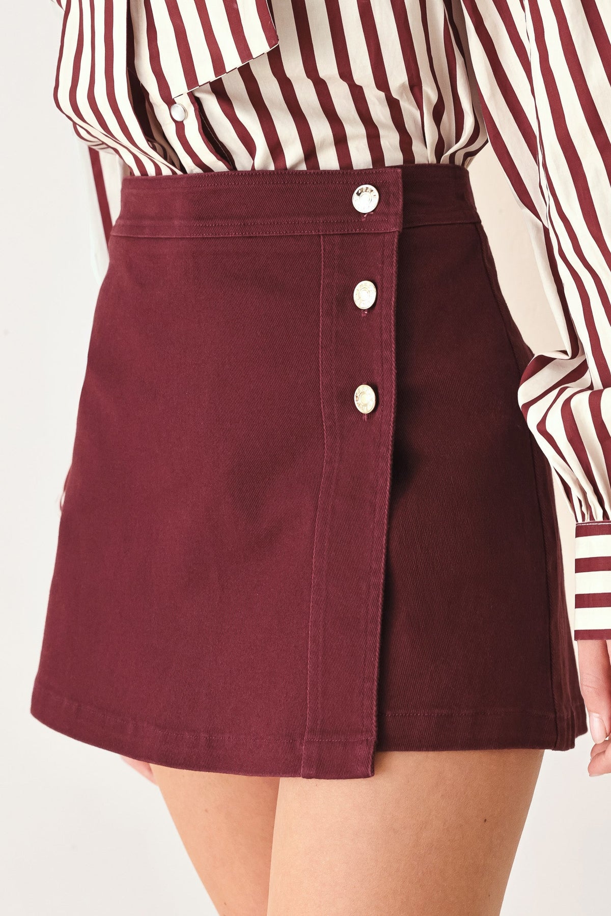 Burgundy woven skort with side-button closure and A-line skirt overlay