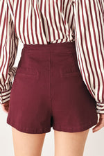 Burgundy woven skort with tailored shorts silhouette and side panel seams