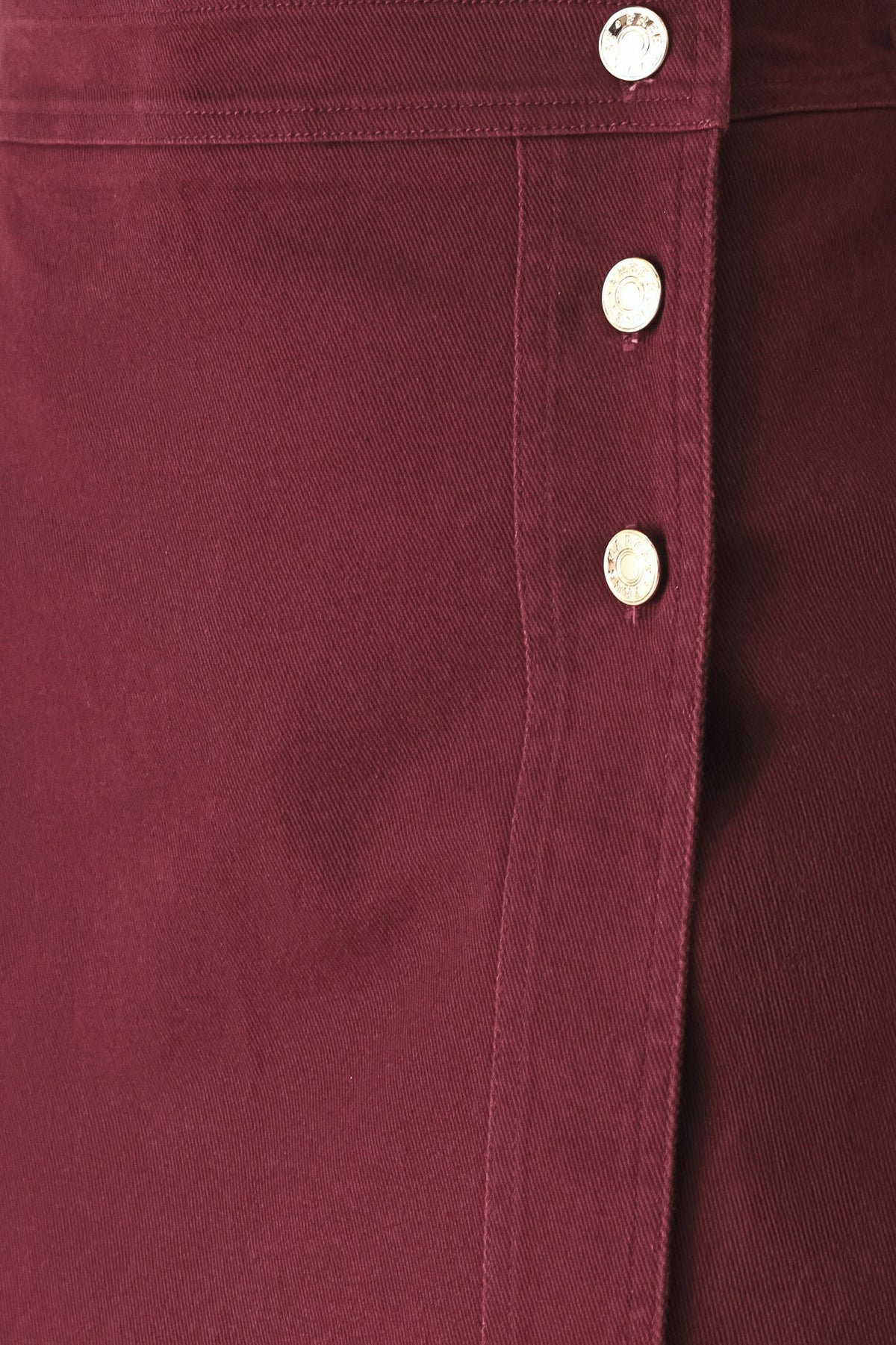 Burgundy woven skort close-up of button placket and fabric seam