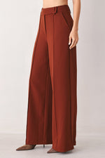 Rust woven wide-leg trousers with relaxed flowy legs and button front