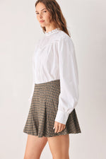 Brown tweed check skort from side view with pleated flared hem