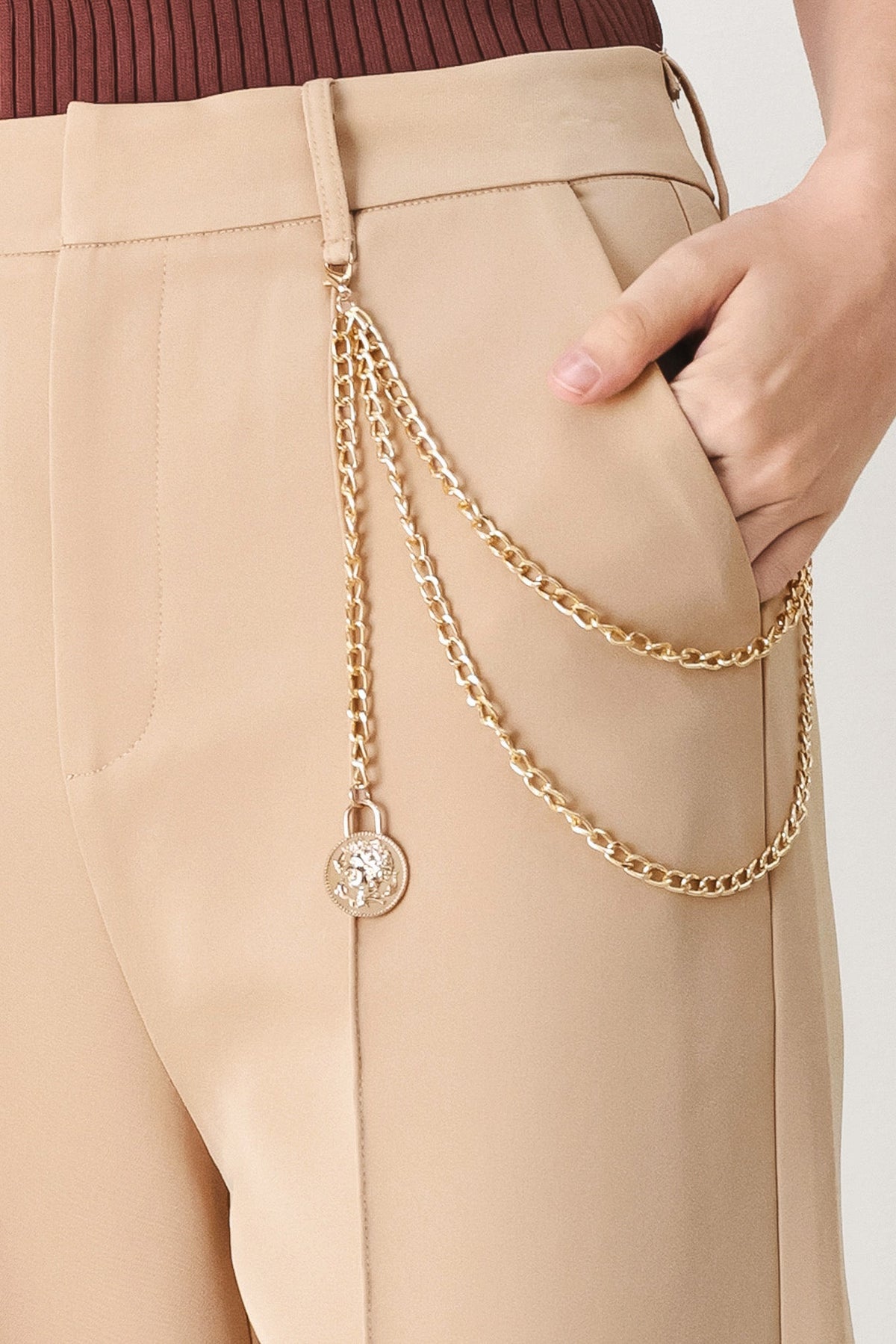 Camel woven pants with gold-tone drape chain and round charm on the pocket