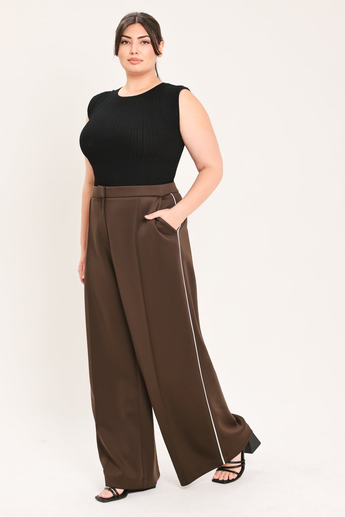 Brown wide-leg stretch pants with front crease and contrast stripe down leg