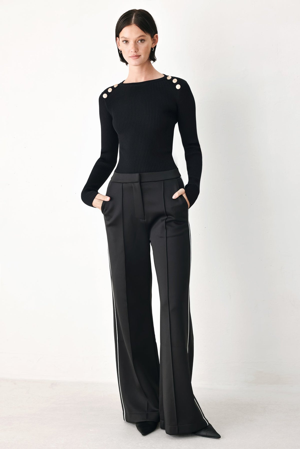 Black wide-leg pants with pintuck front, smooth waistband, and white side stripe