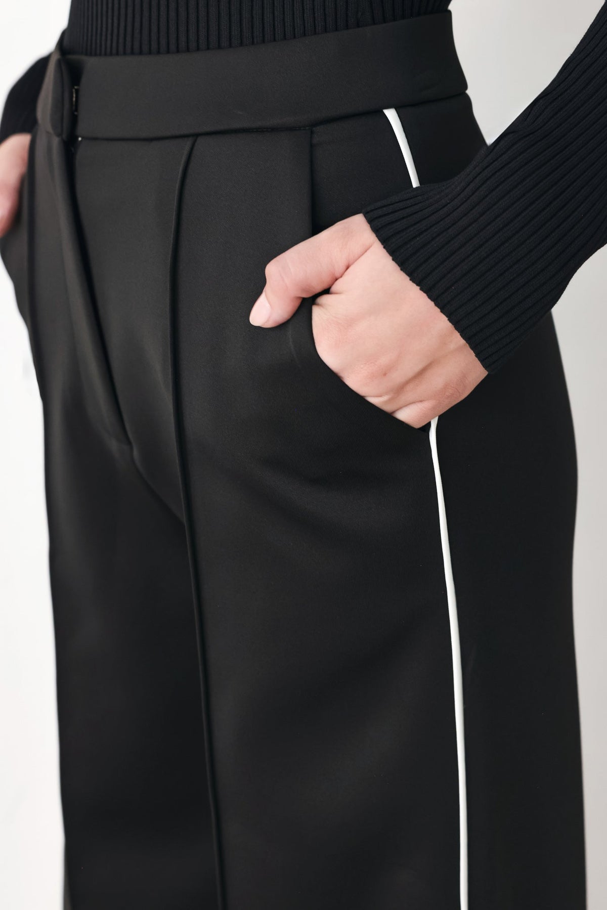 Black pants waist and hip detail with belt loops and white side stripe