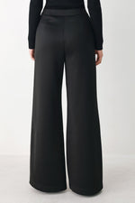 Black wide-leg pants front view with smooth front pleats and white side stripe