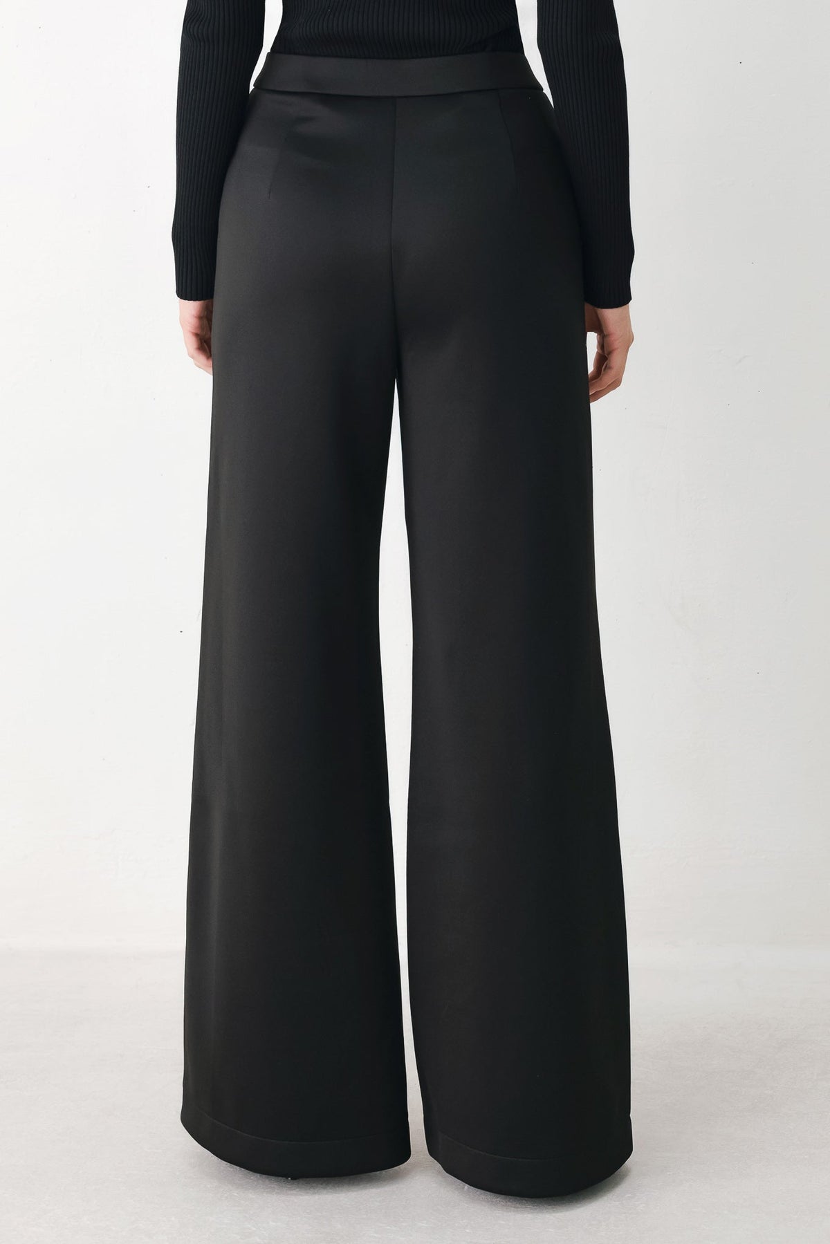 Black wide-leg pants front view with smooth front pleats and white side stripe