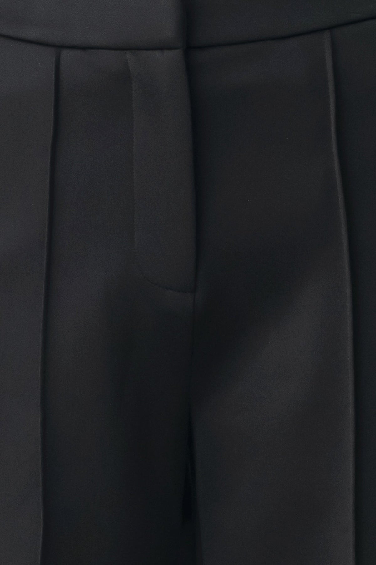 Black pants close-up of front pleats and seam lines