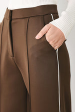 Brown stretch pants with vertical contrast side stripe and tailored seam