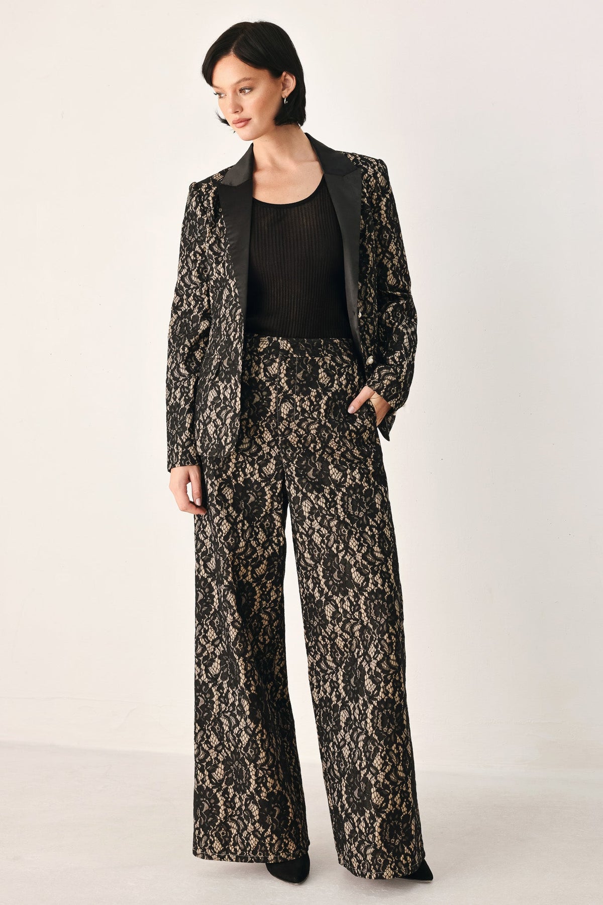 Lace wide-leg pants in black with camel pattern detail, full-length straight legs