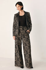 Lace wide-leg pants in black with camel pattern detail, full-length straight legs