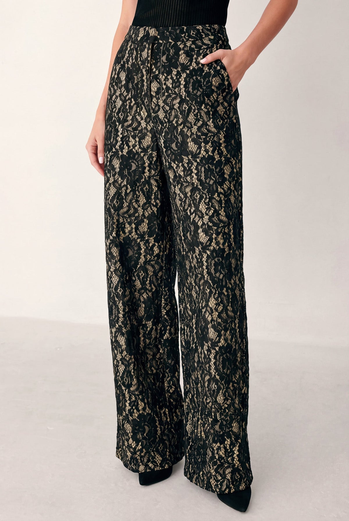 Black and camel lace wide-leg pants with high-rise waist and flowing drape