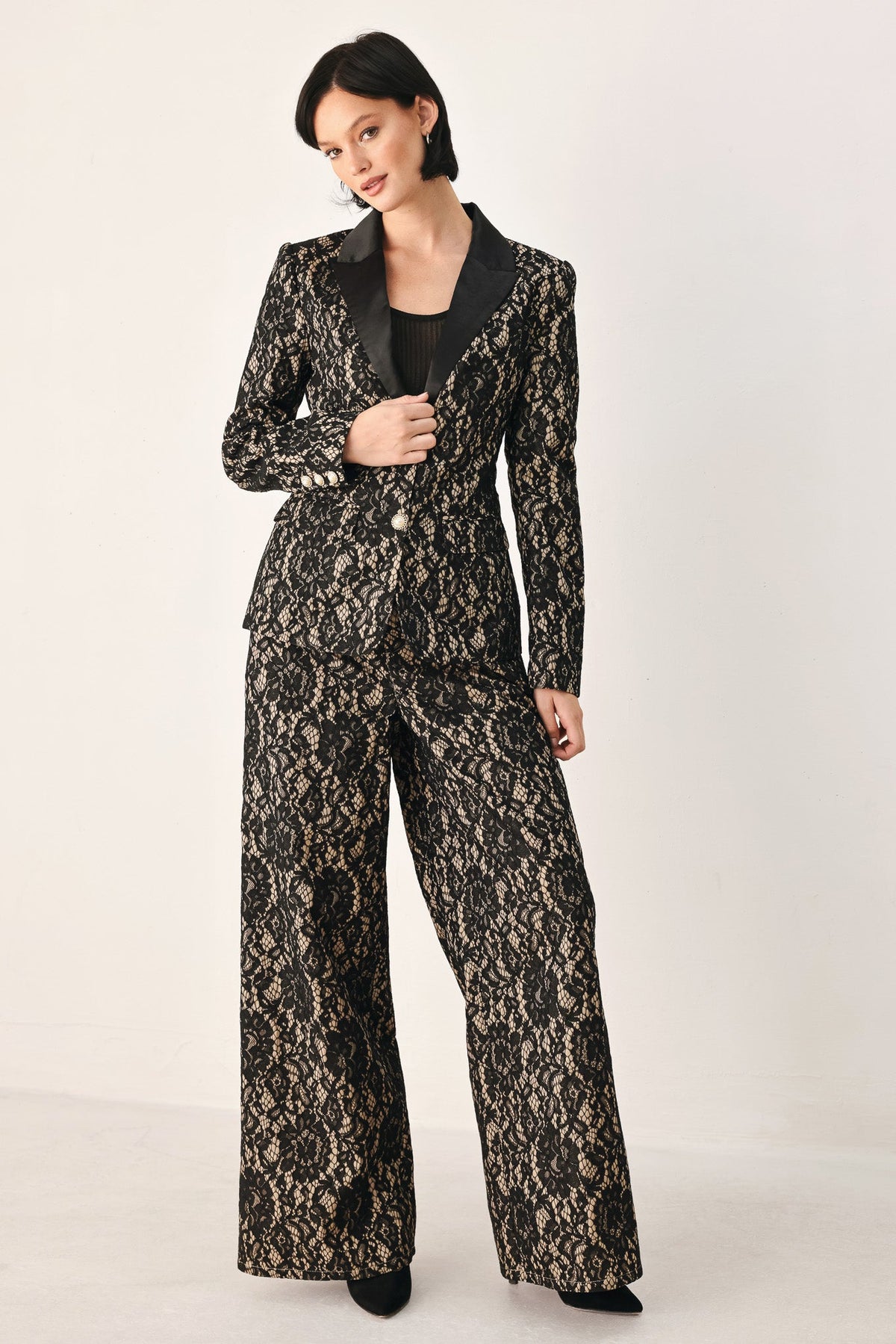 Black and camel lace wide-leg pants with long legs and ornate allover texture