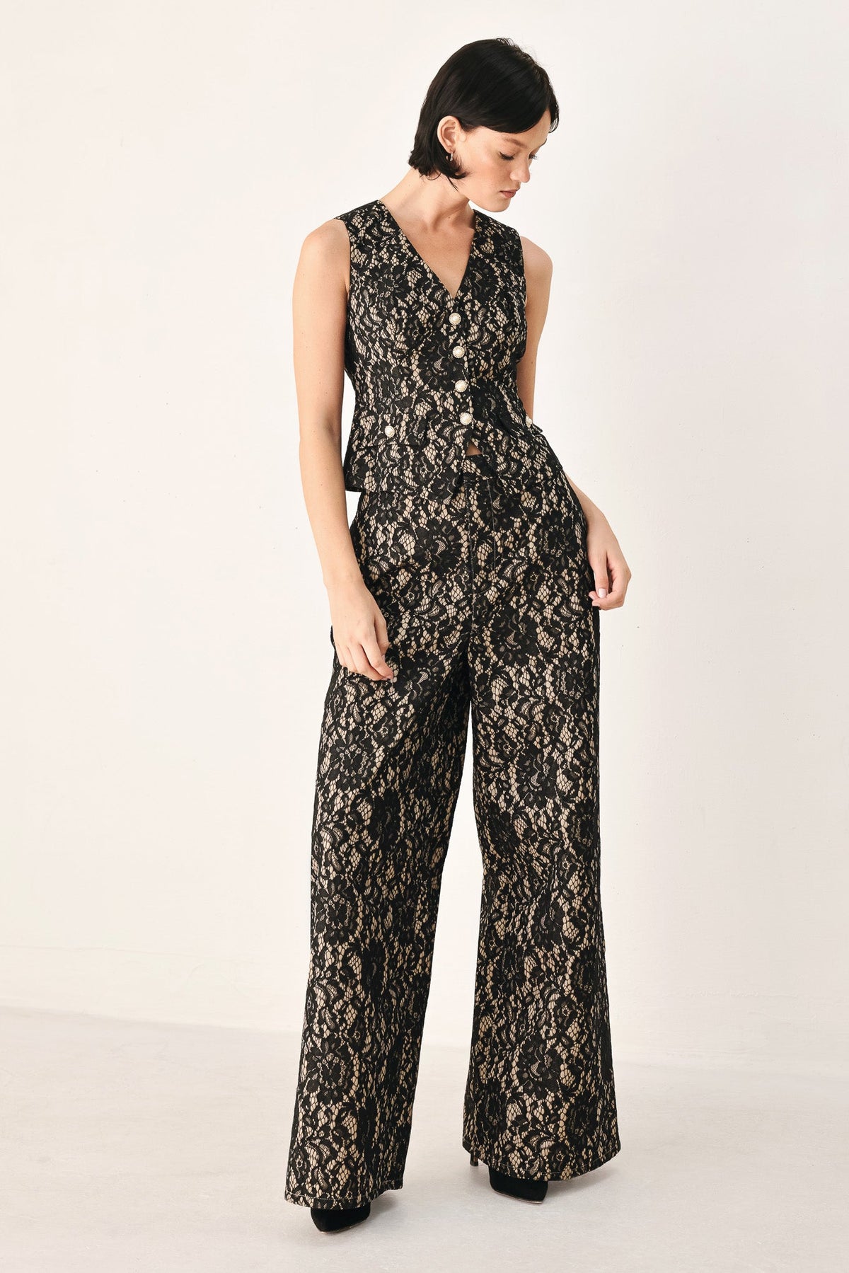 Sleeveless styling look: black and camel lace wide-leg pants with wide flared hems