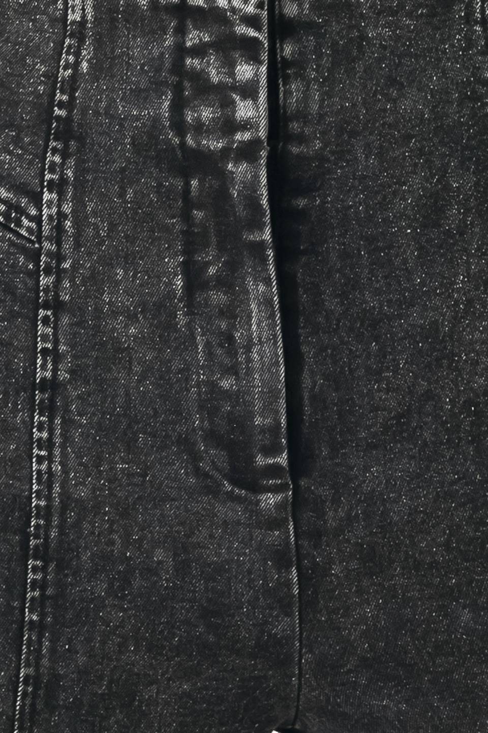 Black denim fabric close-up with textured wash and visible stitching